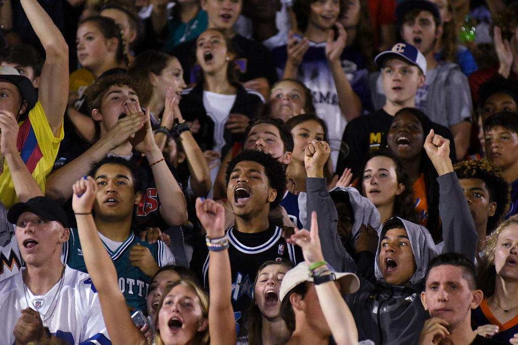 Hickman High School students cheer after their team made a successful play